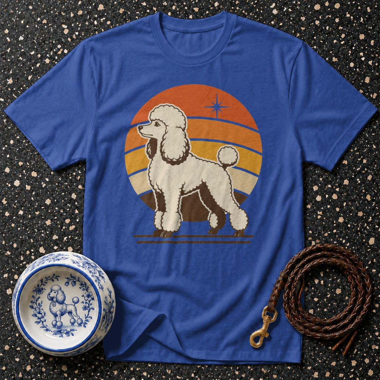 Blue t-shirt with retro poodle graphic and sunset design.