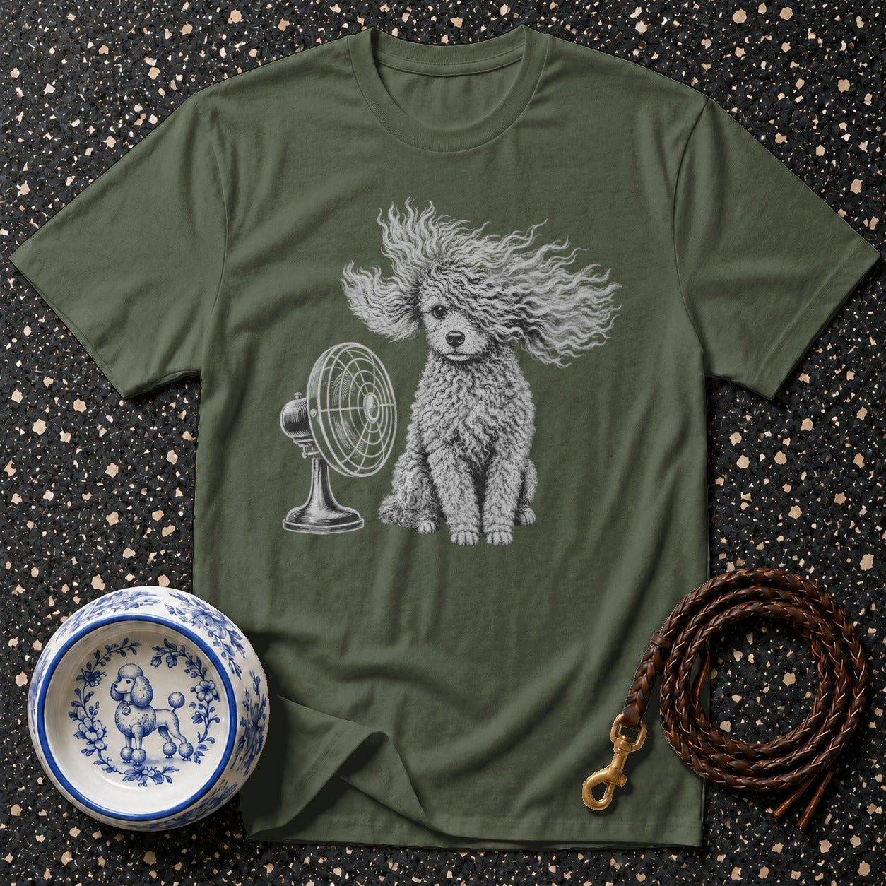 Green t-shirt with poodle graphic blowing in fan wind, dog bowl, and leash.