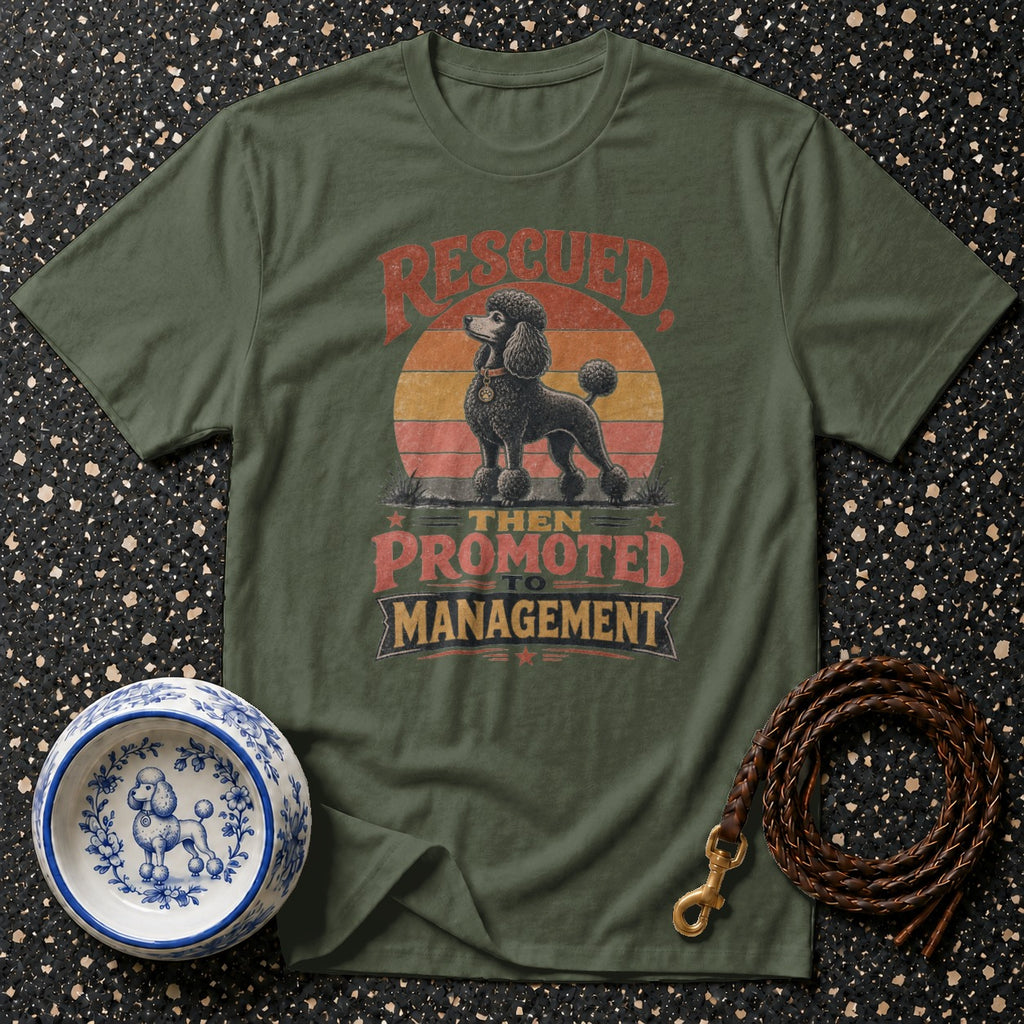 Green t-shirt with rescued poodle graphic, "then promoted to management" text.
