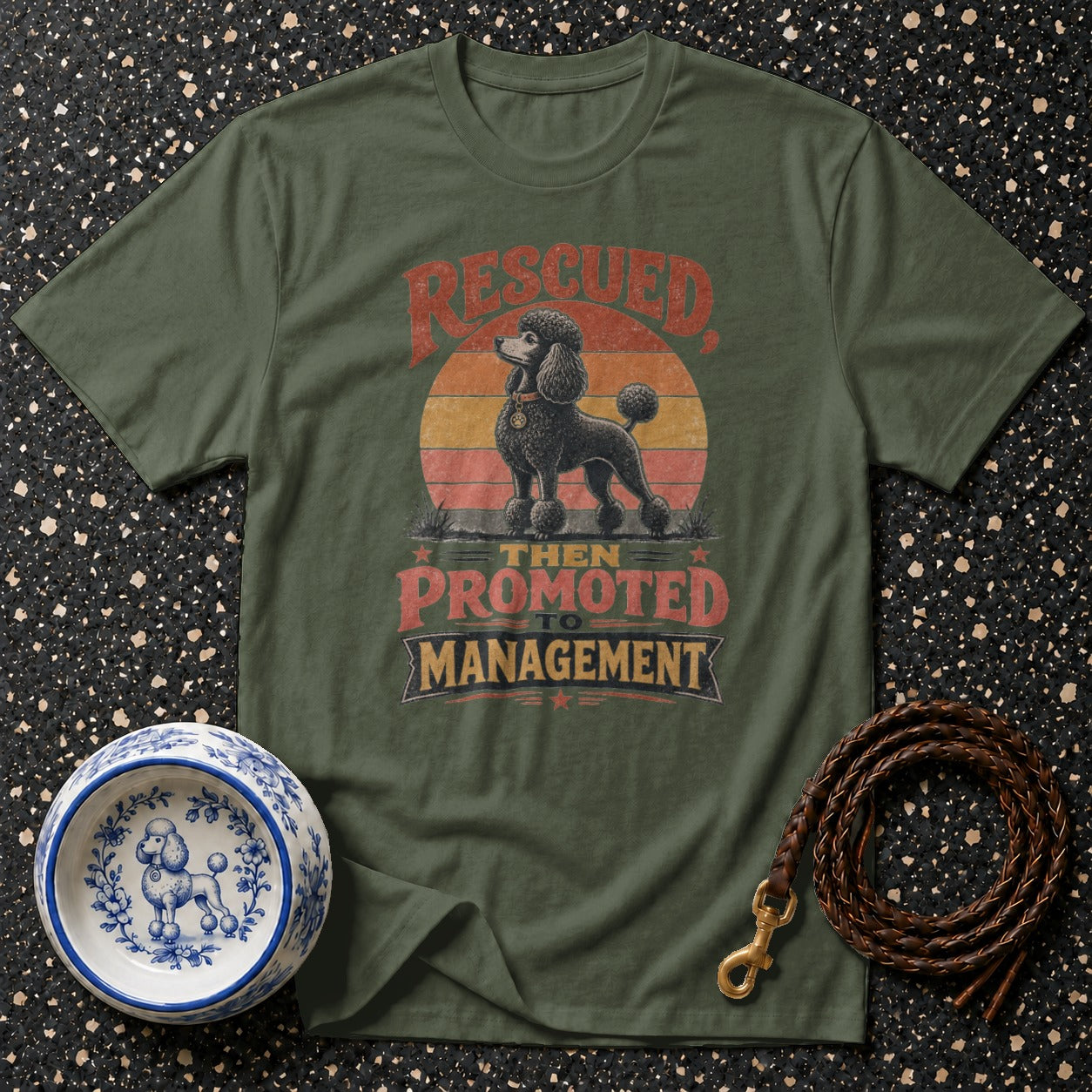 Green t-shirt with rescued poodle graphic, "then promoted to management" text.
