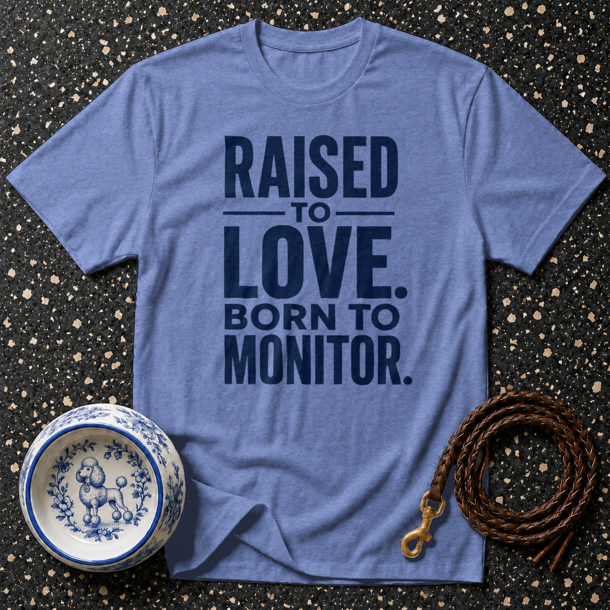 Blue t-shirt with dark blue text "RAISED TO LOVE. BORN TO MONITOR."