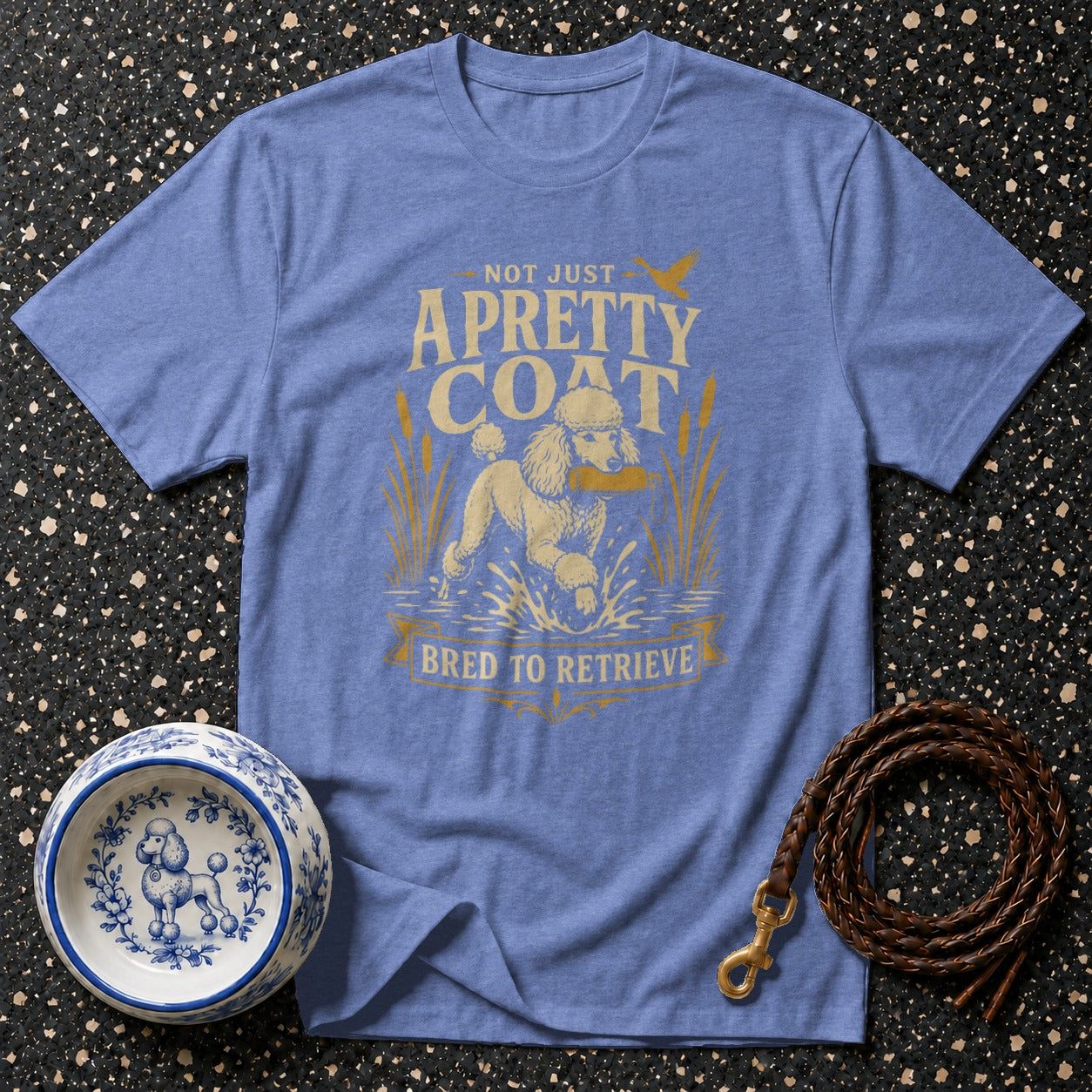 Blue t-shirt with "Not Just A Pretty Coat, Bred To Retrieve" text and poodle graphic.