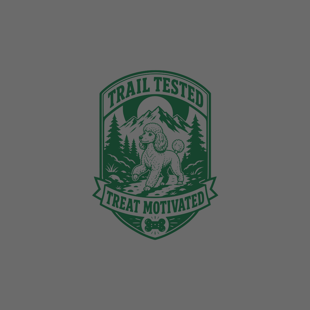 Poodle on trail with mountains, pine trees, and text "Trail Tested Treat Motivated".