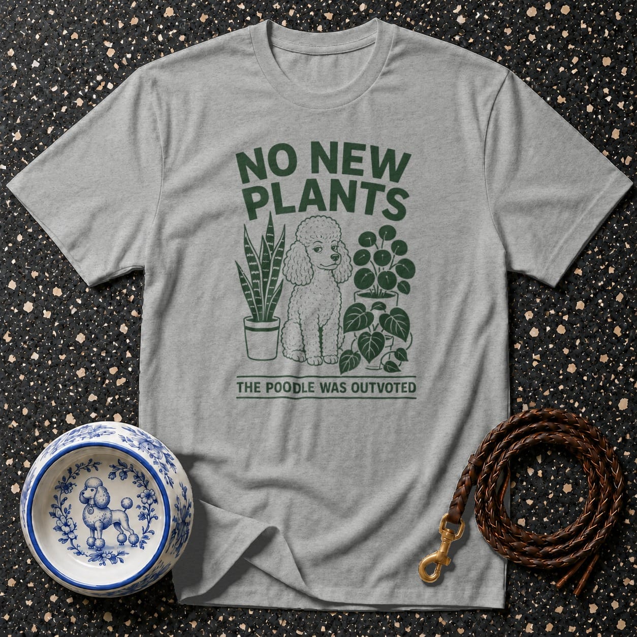 Grey t-shirt with green text "No New Plants" and a poodle illustration.