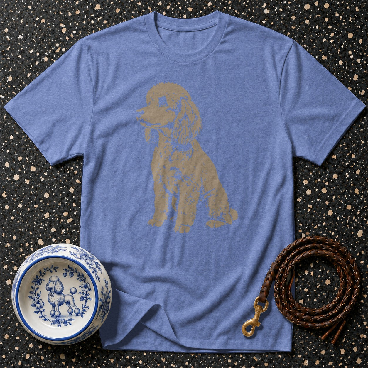 Blue t-shirt with a gold poodle graphic, dog bowl, and leather leash.