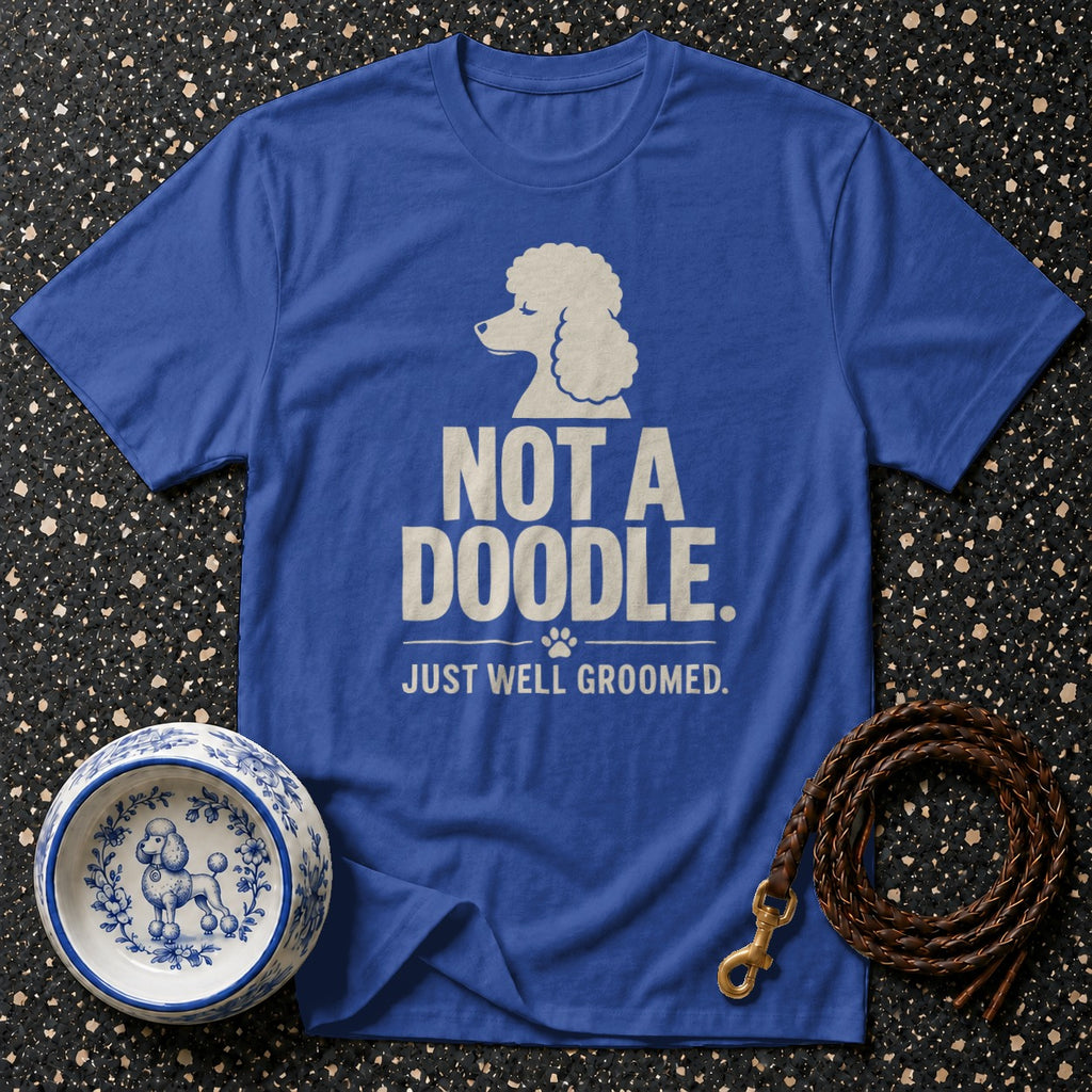 Blue t-shirt with a poodle graphic and text "NOT A DOODLE. JUST WELL GROOMED."
