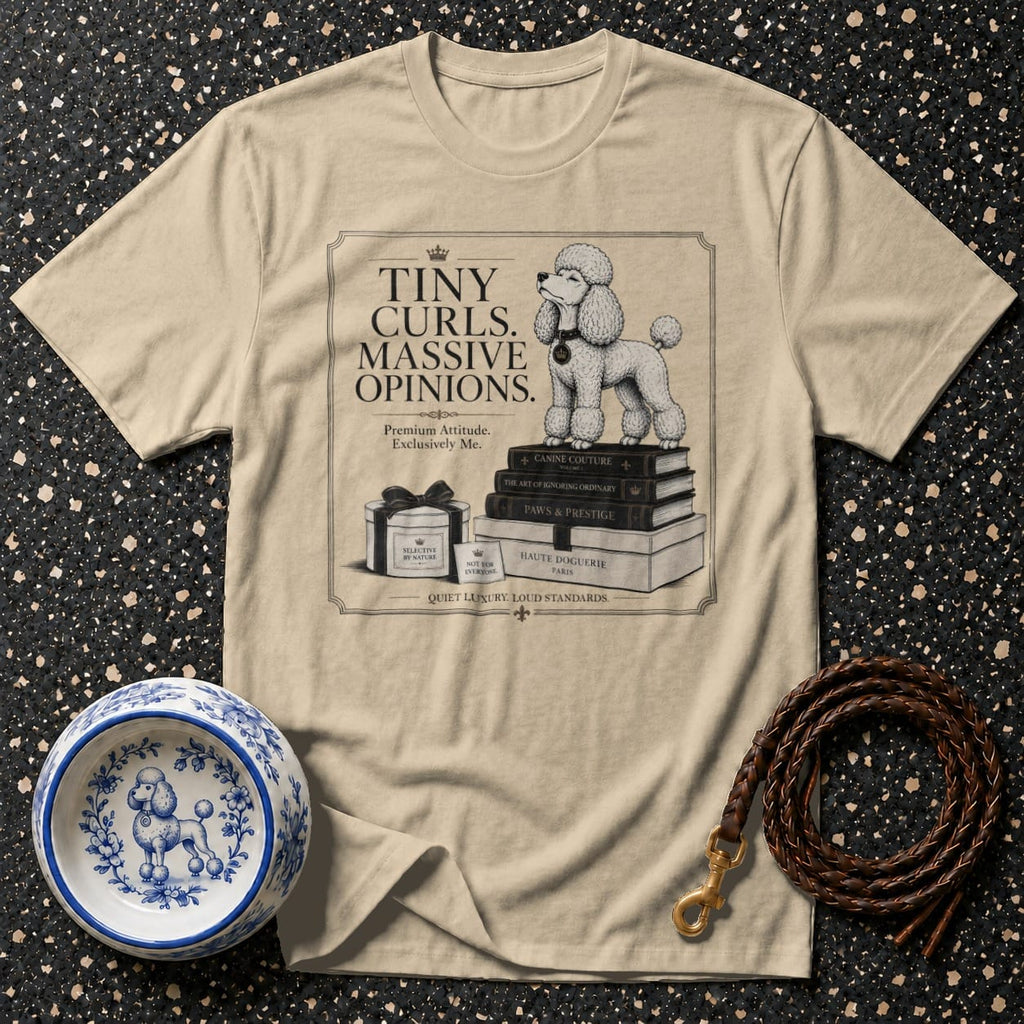 Beige t-shirt with poodle on books, "Tiny Curls. Massive Opinions." text, and dog accessories.