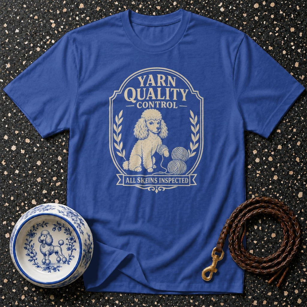 Blue t-shirt with a cream-colored poodle inspecting skeins of yarn with text "Yarn Quality Control All Skeins Inspected".