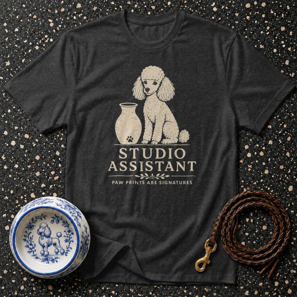 Dark t-shirt with white poodle graphic and "STUDIO ASSISTANT" text.