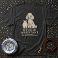 Dark t-shirt with white poodle graphic and "STUDIO ASSISTANT" text.