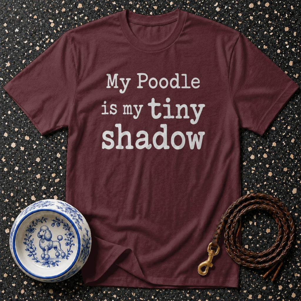 Maroon t-shirt with white text that reads "My Poodle is my tiny shadow".