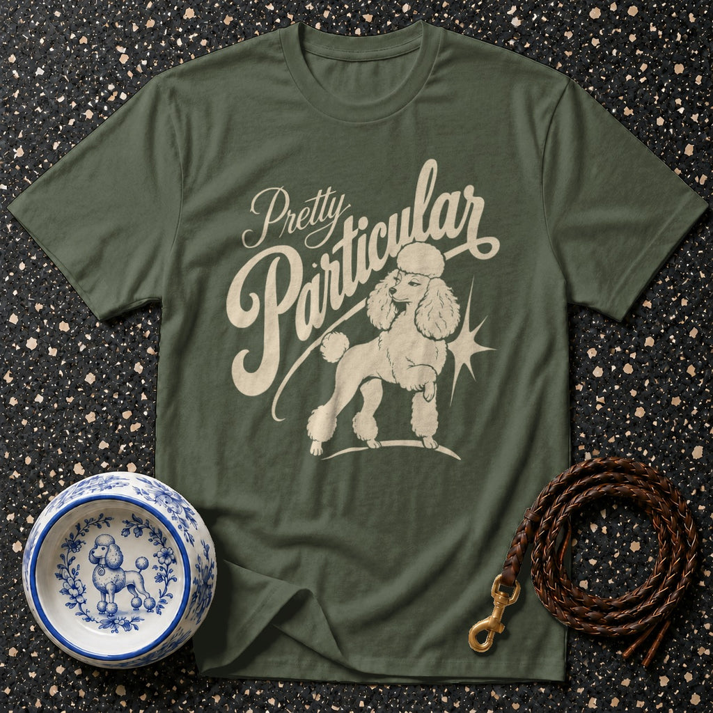 Olive green t-shirt with "Pretty Particular" and poodle graphic.