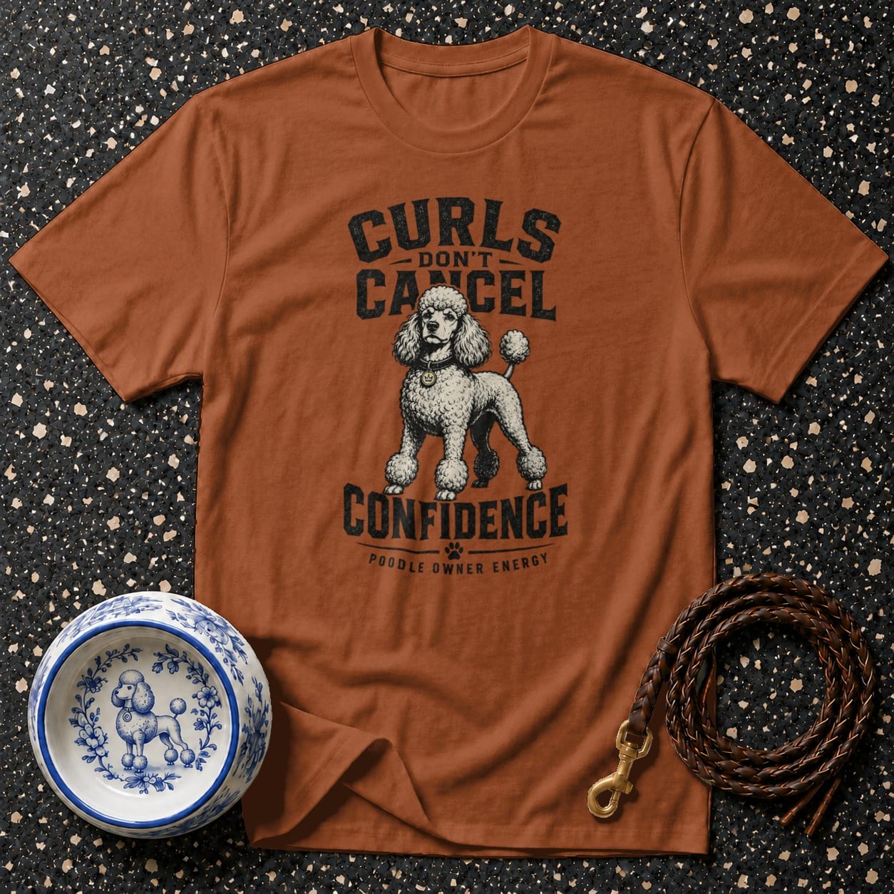 Brown t-shirt with poodle graphic and text: Curls Don't Cancel Confidence.