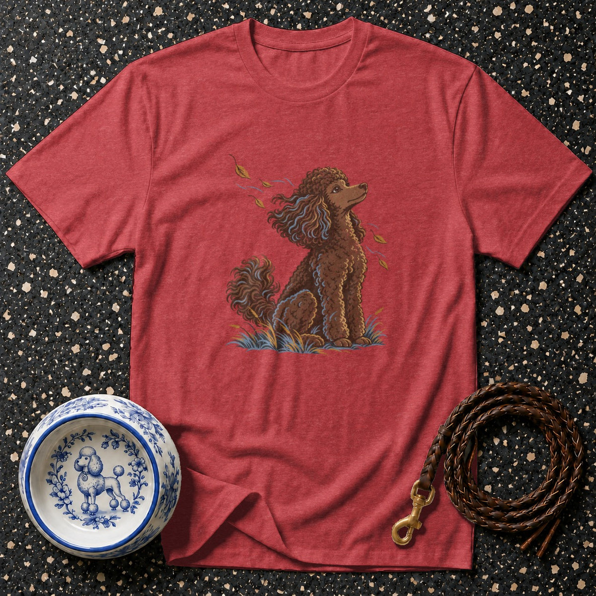 Red t-shirt with brown poodle illustration, white dog bowl, and braided leash.