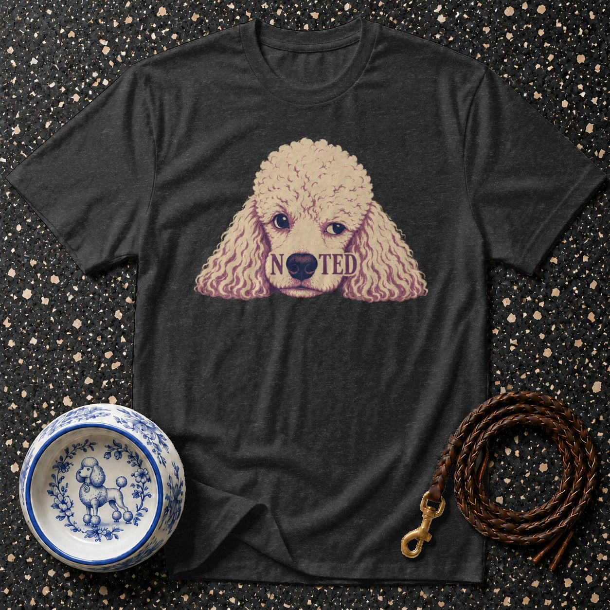 Dark grey t-shirt with a poodle graphic that reads "NOTED".