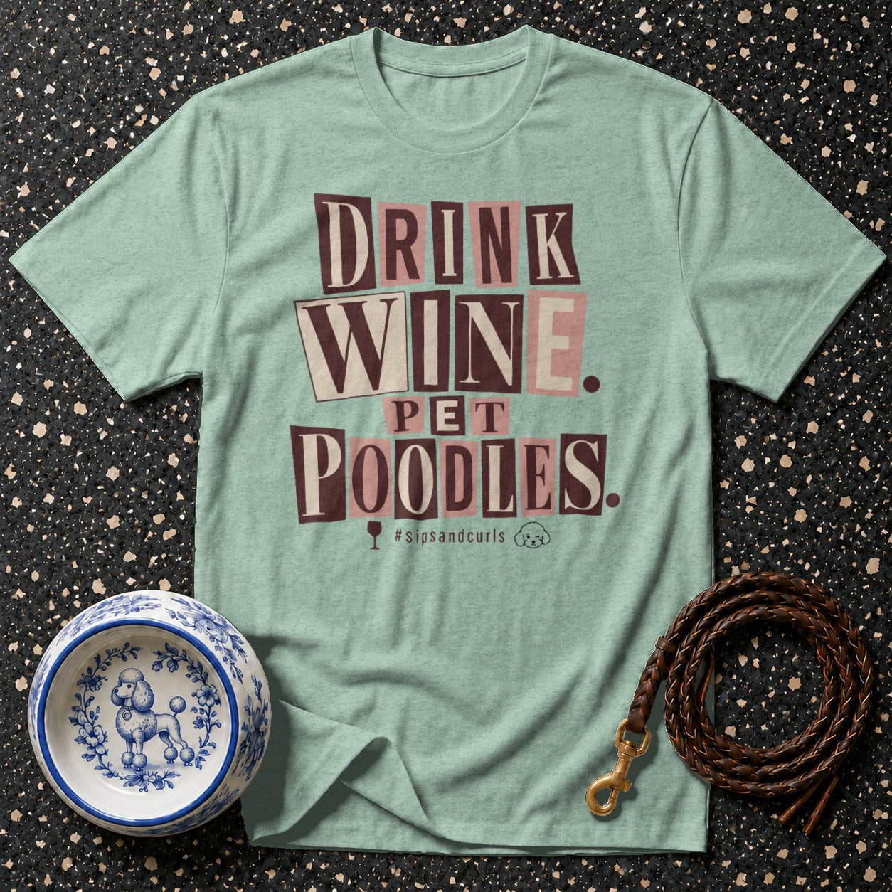 Light green t-shirt with "DRINK WINE PET POODLES" text and hashtag.