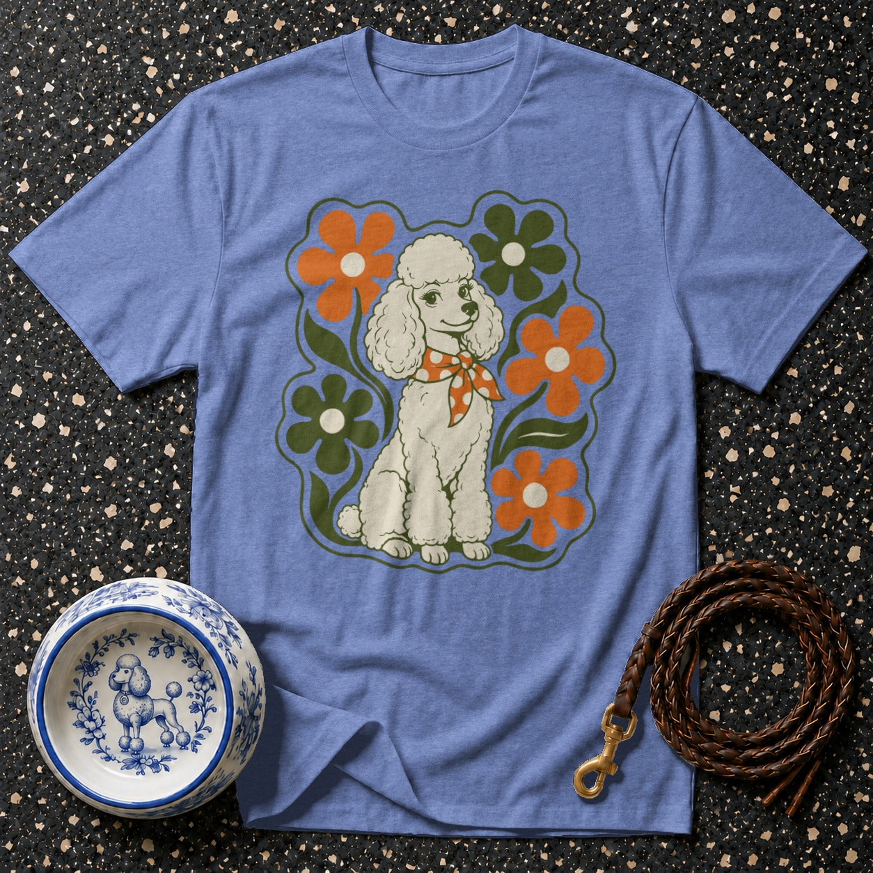 Blue t-shirt with retro white poodle graphic and floral accents.