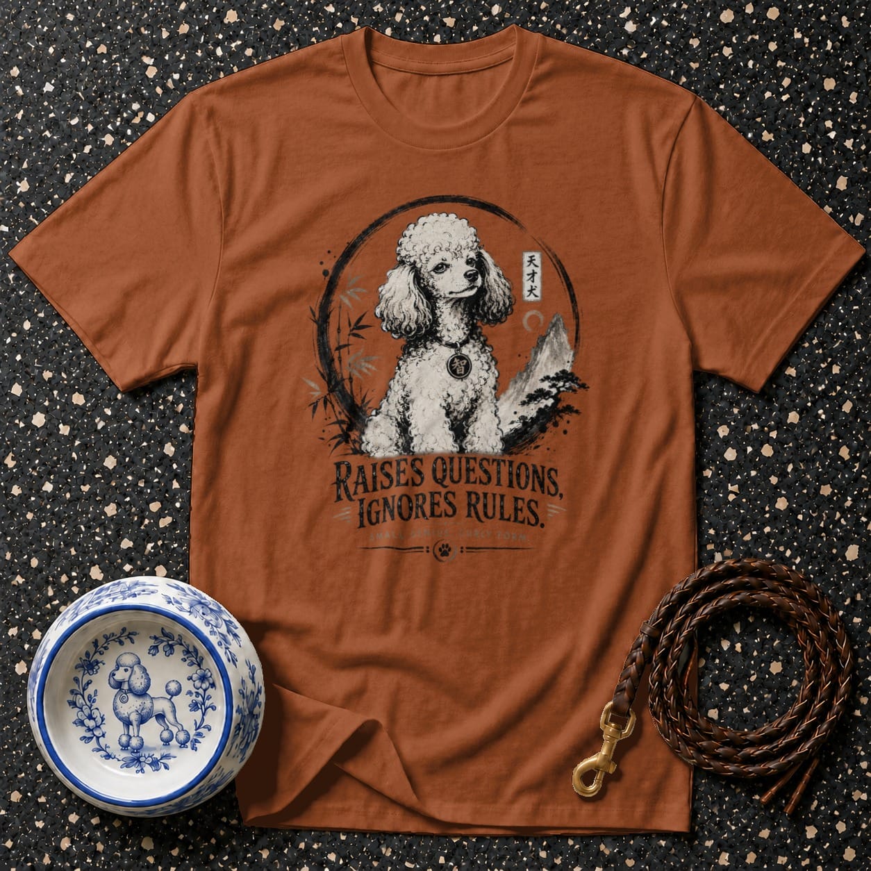 Brown t-shirt with poodle illustration and text "RAISES QUESTIONS. IGNORES RULES."