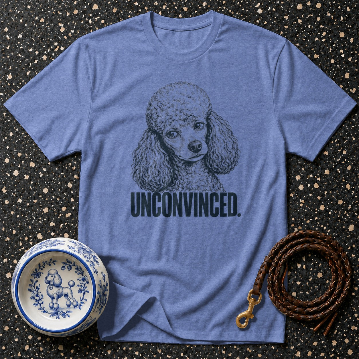 Blue t-shirt with a drawing of a poodle and the text "UNCONVINCED".