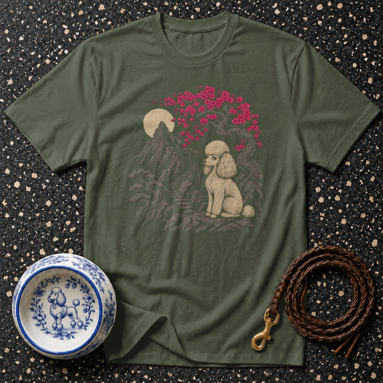 Green t-shirt with a serene poodle scene featuring mountains and a cherry blossom tree.