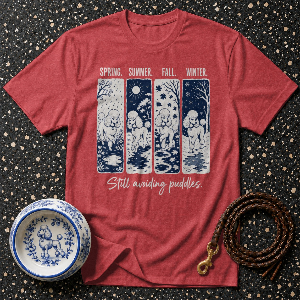 Red t-shirt with four poodle scenes and text "Still avoiding puddles."