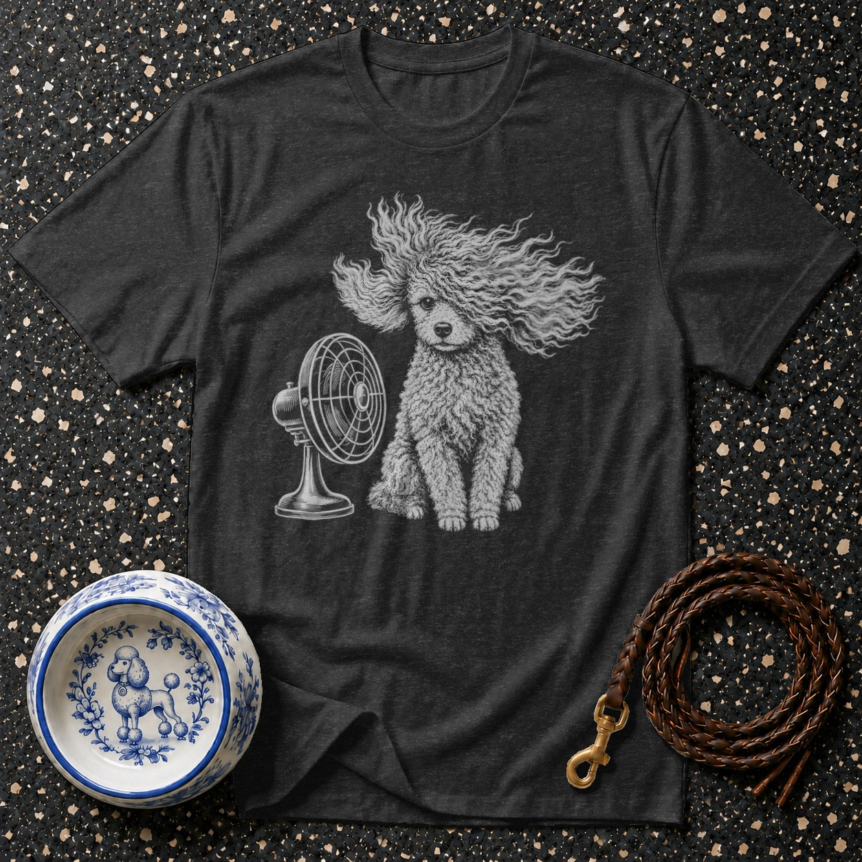 Dark t-shirt with a poodle sitting in front of a fan, dog bowl, and leash.