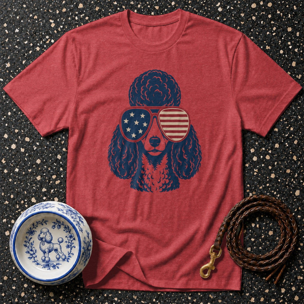 Red t-shirt with blue poodle wearing American flag sunglasses, dog bowl, and leash.