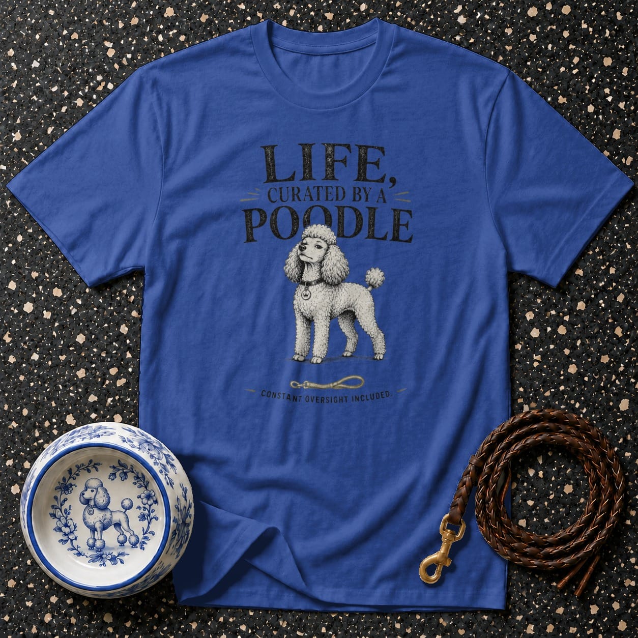 Royal blue t-shirt with text and poodle graphic, a leash, and a bowl.