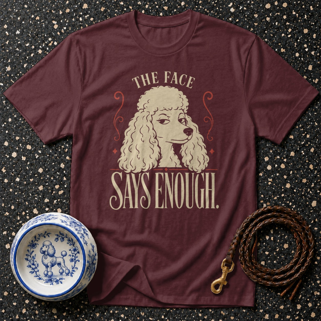Maroon t-shirt with a poodle graphic that says "The face says enough."
