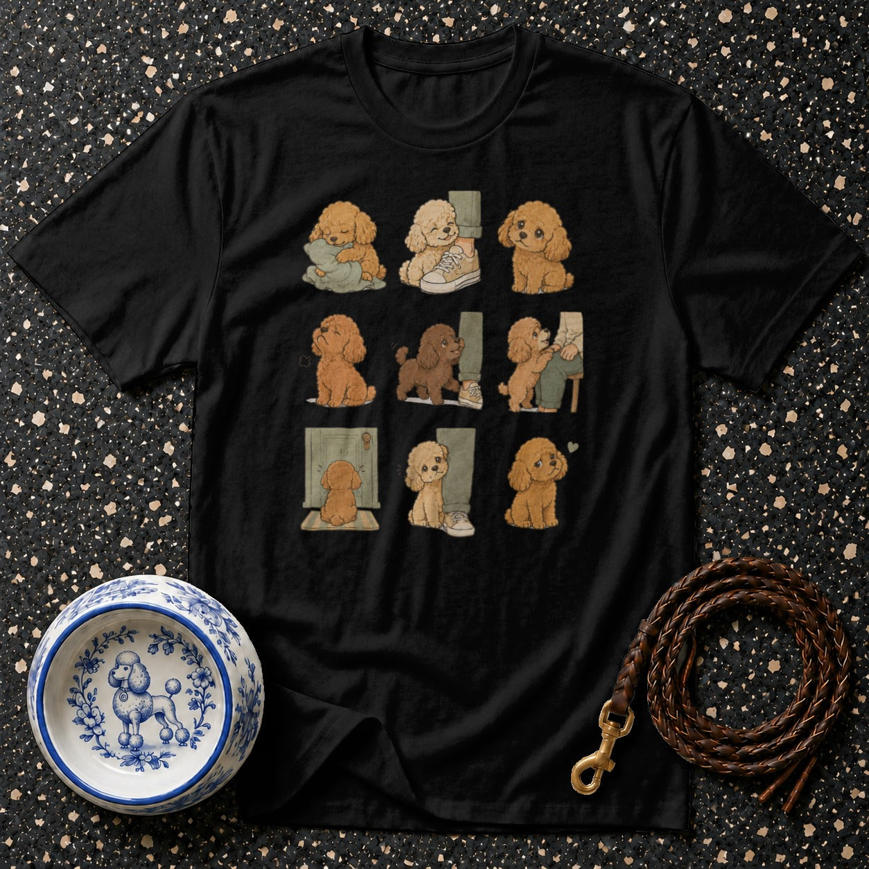 Black t-shirt with nine cartoon poodles in various adorable poses.
