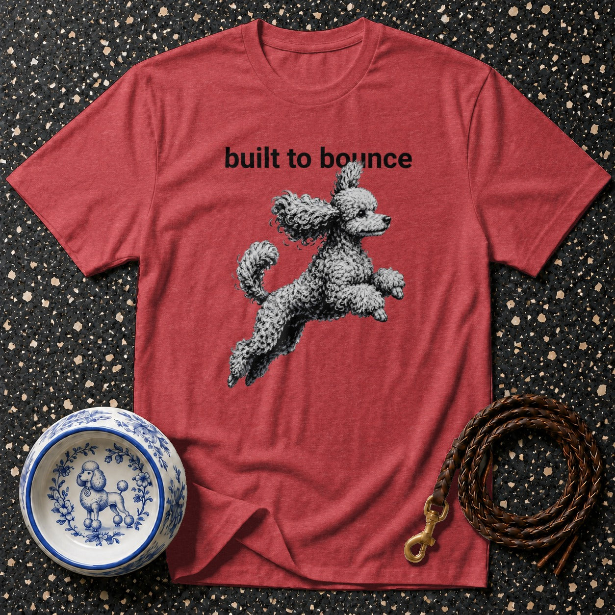 Red t-shirt with "built to bounce" text and jumping poodle graphic.