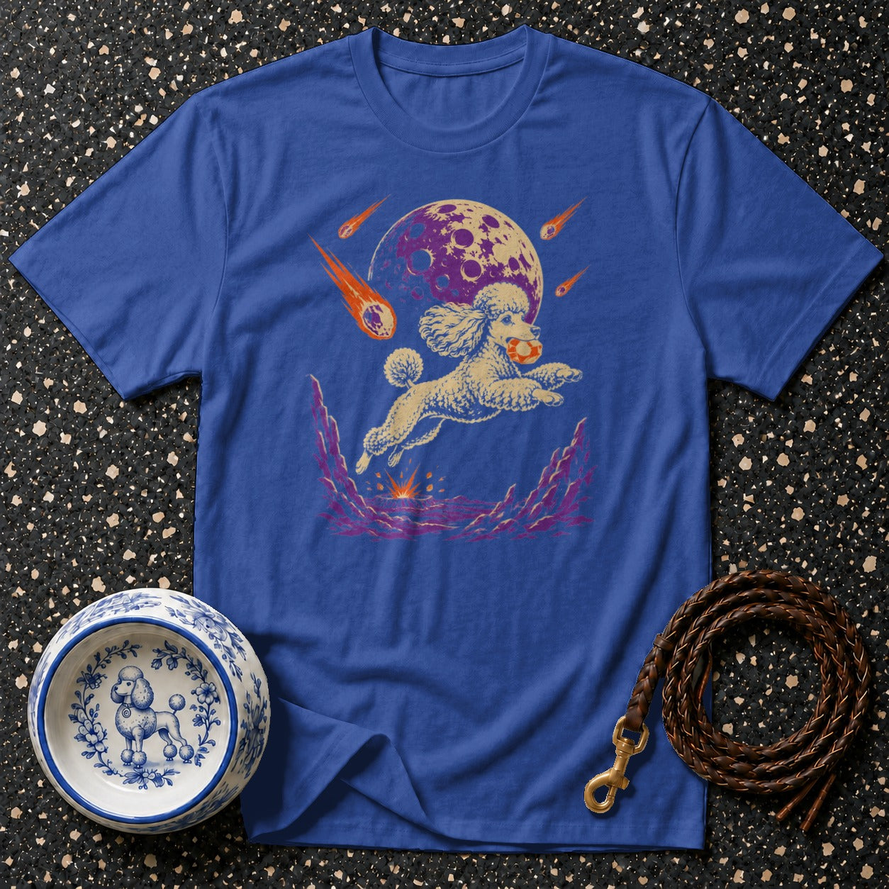 Blue t-shirt with a poodle jumping through space with meteors and a moon.