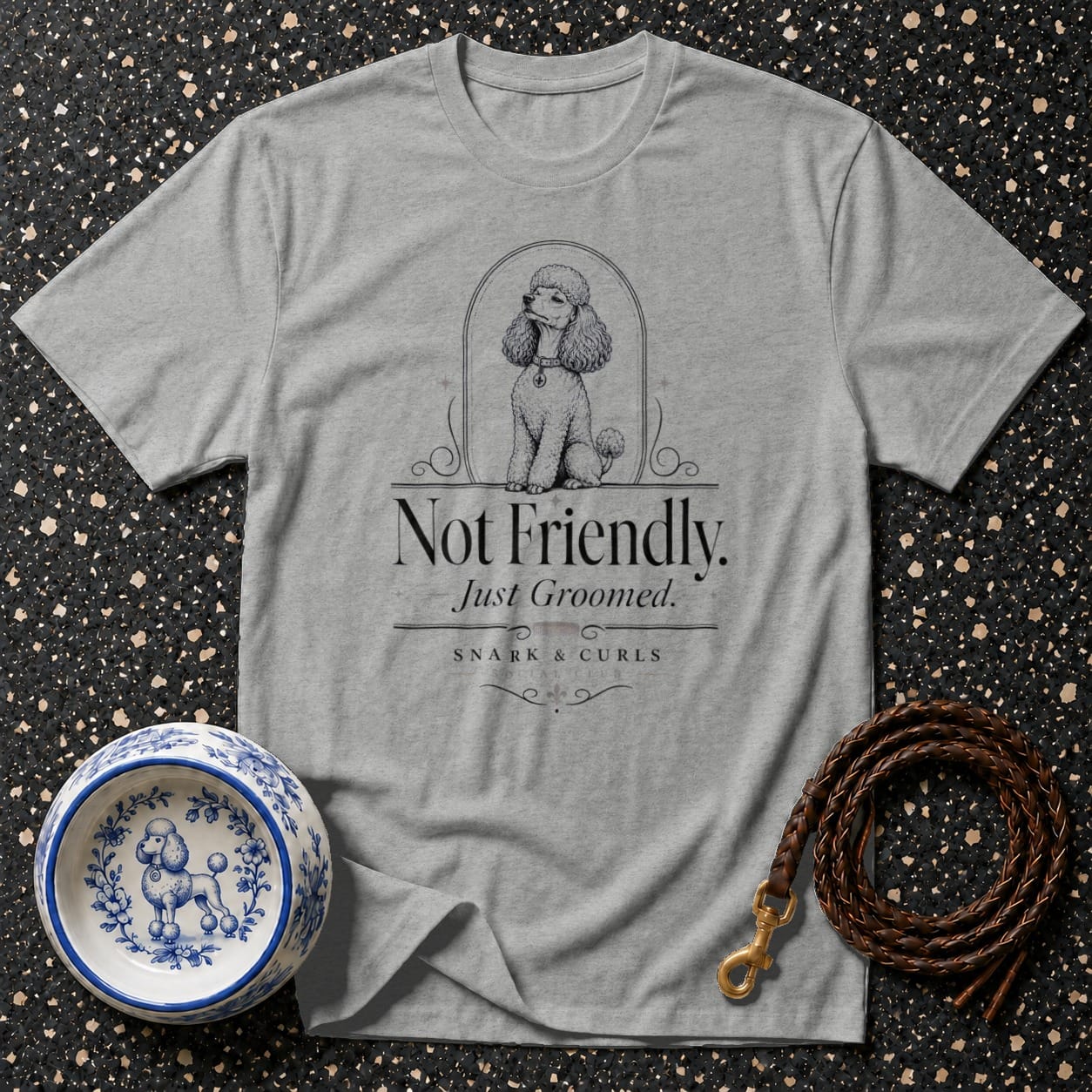 Grey t-shirt with poodle graphic and text "Not Friendly. Just Groomed. SNARK & CURLS."