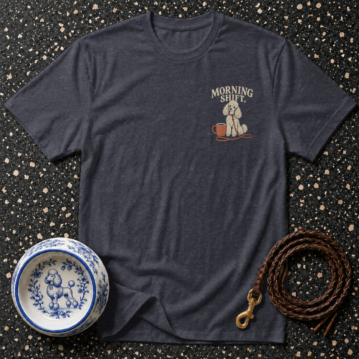 Dark t-shirt with a small embroidered graphic of a poodle and coffee cup, text "MORNING SHIFT."