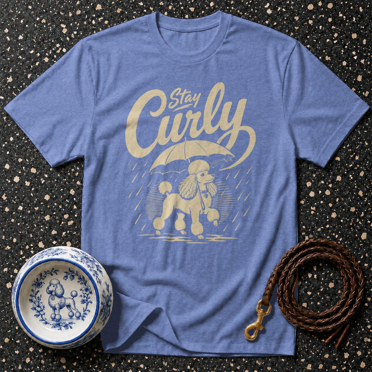 Blue t-shirt with "Stay Curly" text and poodle under umbrella graphic.