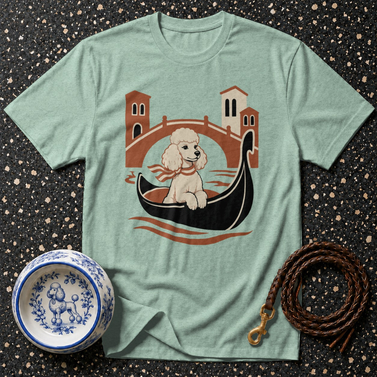 Poodle in a gondola with Venice bridge and buildings.