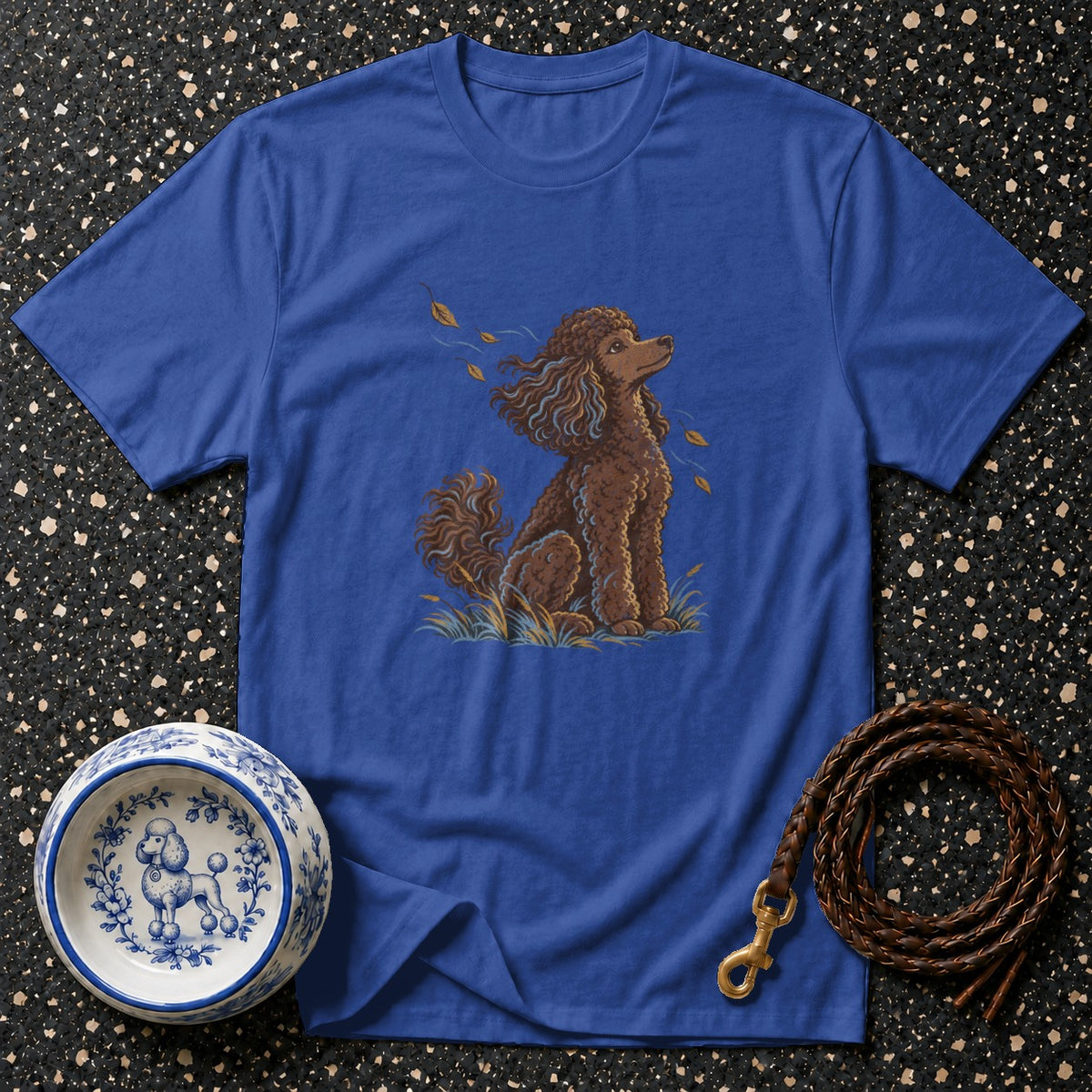 Blue t-shirt with brown poodle illustration, dog bowl, and leather leash.