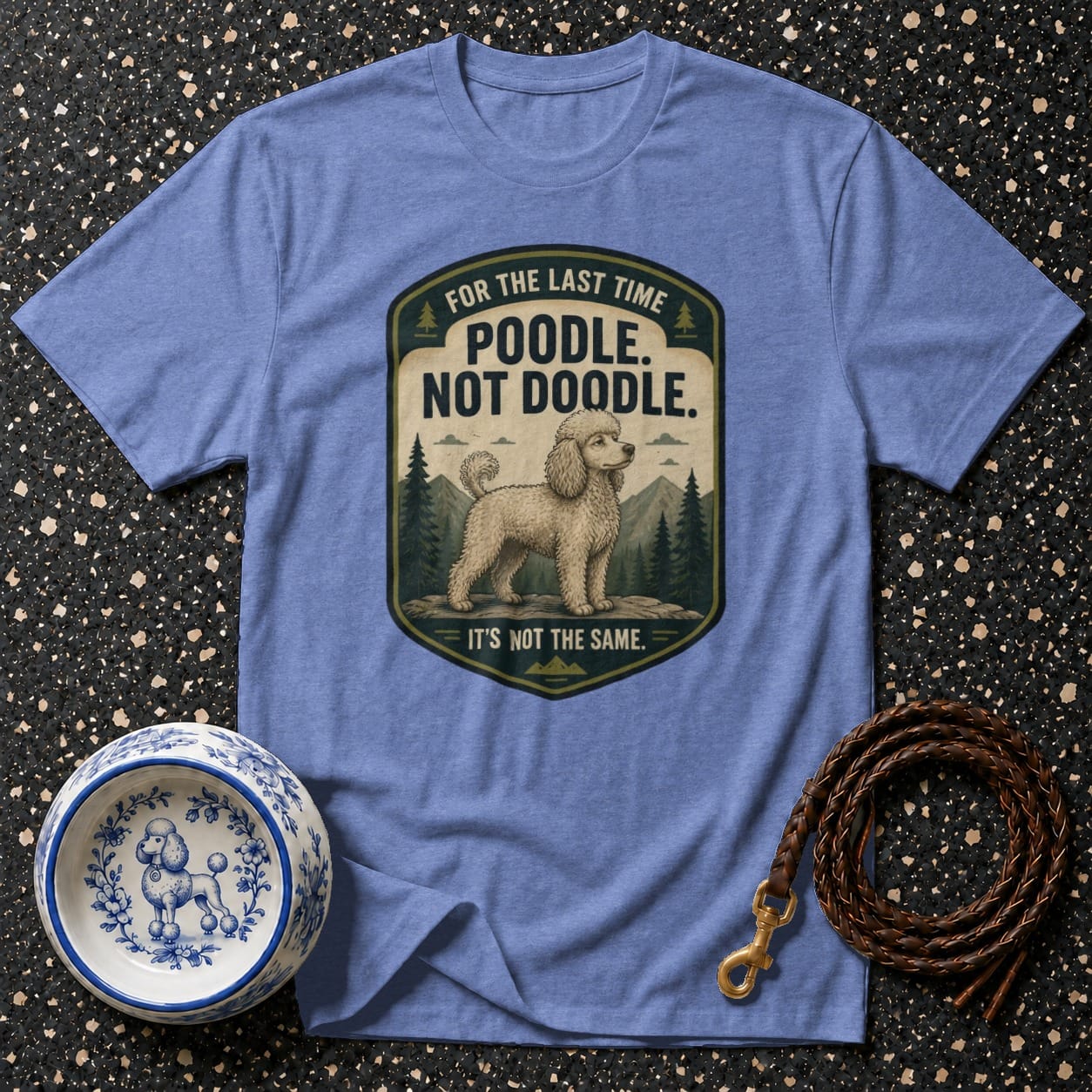 Blue t-shirt with "Poodle. Not Doodle. It's Not The Same." text and poodle illustration.