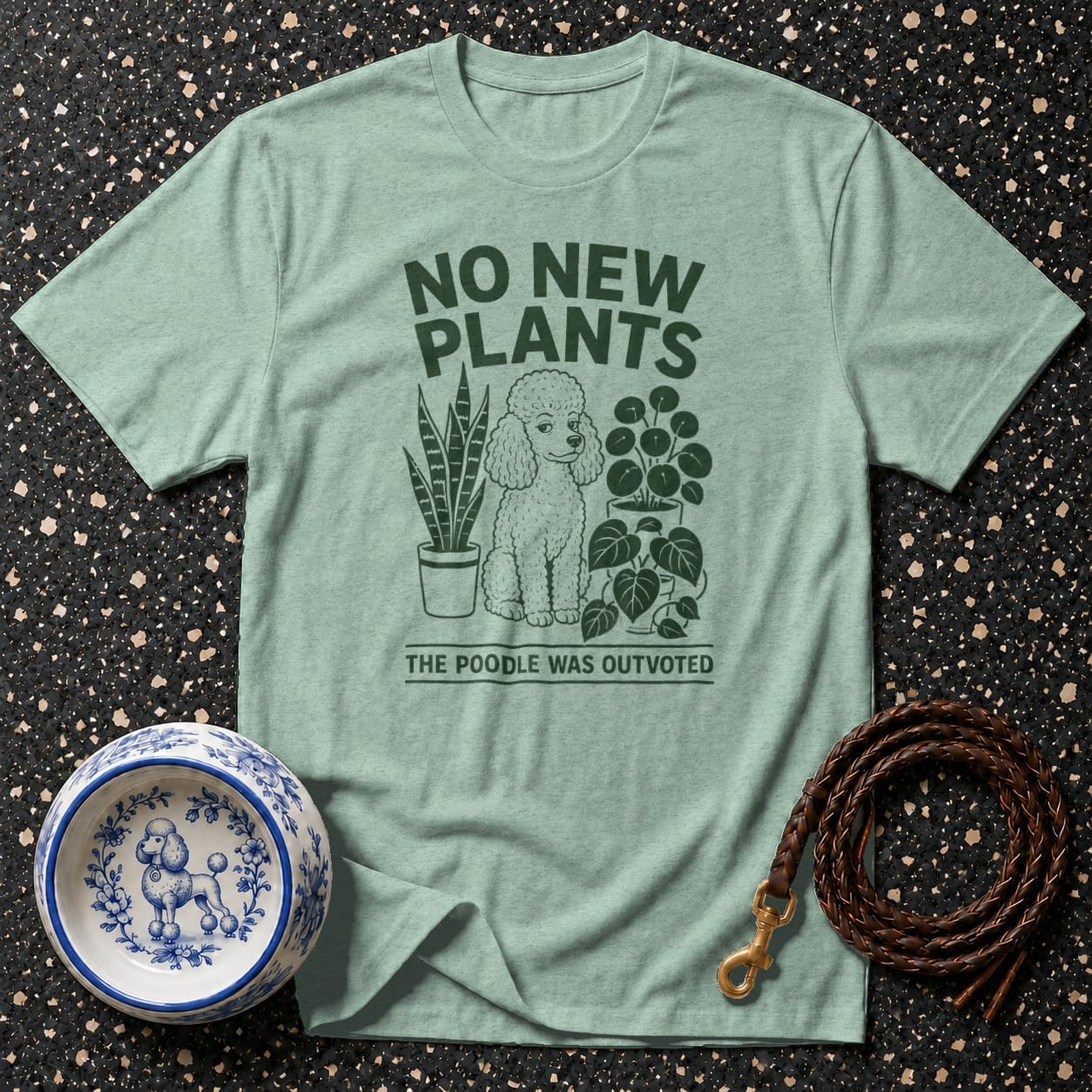 Light green t-shirt with "NO NEW PLANTS THE POODLE WAS OUTVOTED" text and graphic.