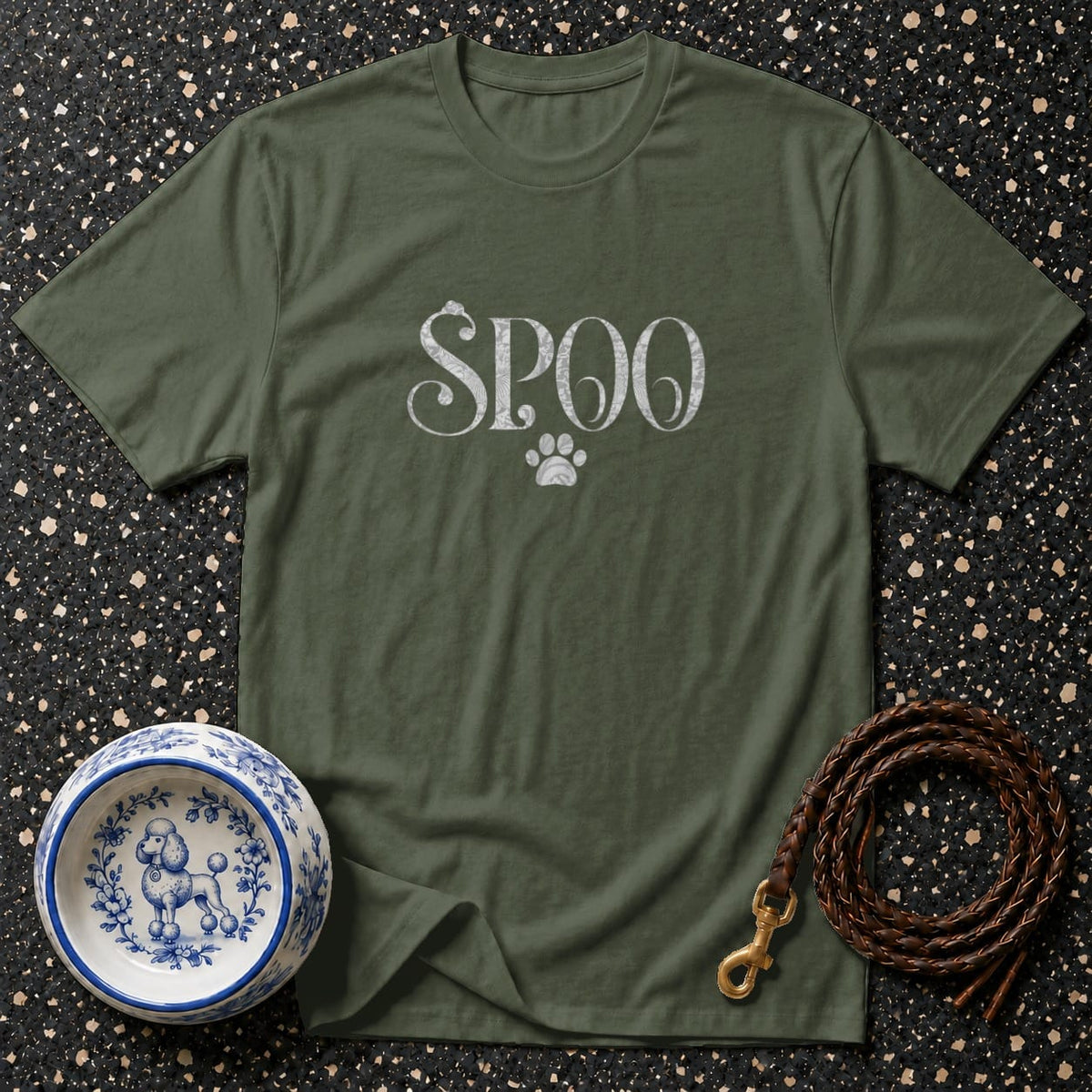 Olive green t-shirt with "SPOO" text and paw print above ornate poodle bowl and leash.