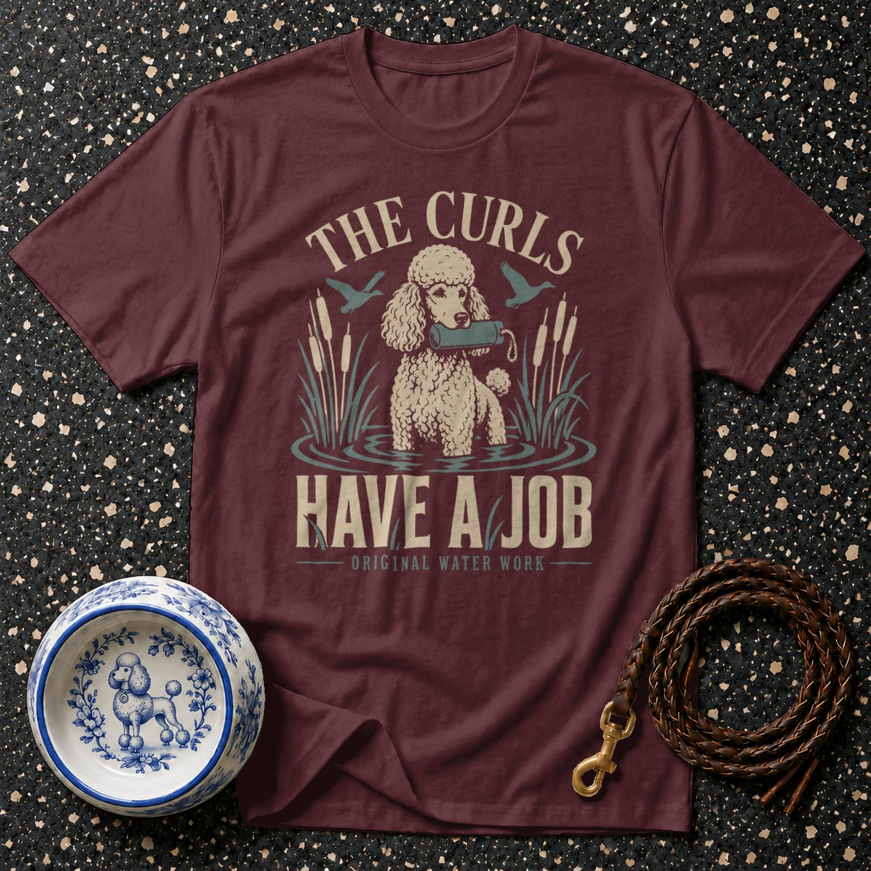 Maroon t-shirt with graphic: "THE CURLS HAVE A JOB - ORIGINAL WATER WORK".