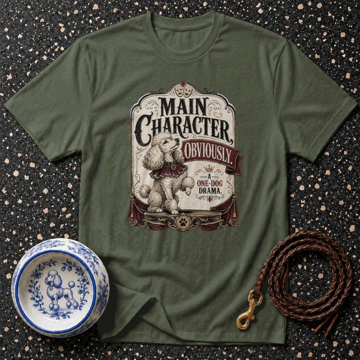Olive green t-shirt featuring a poodle on stage with text "Main Character Obviously".
