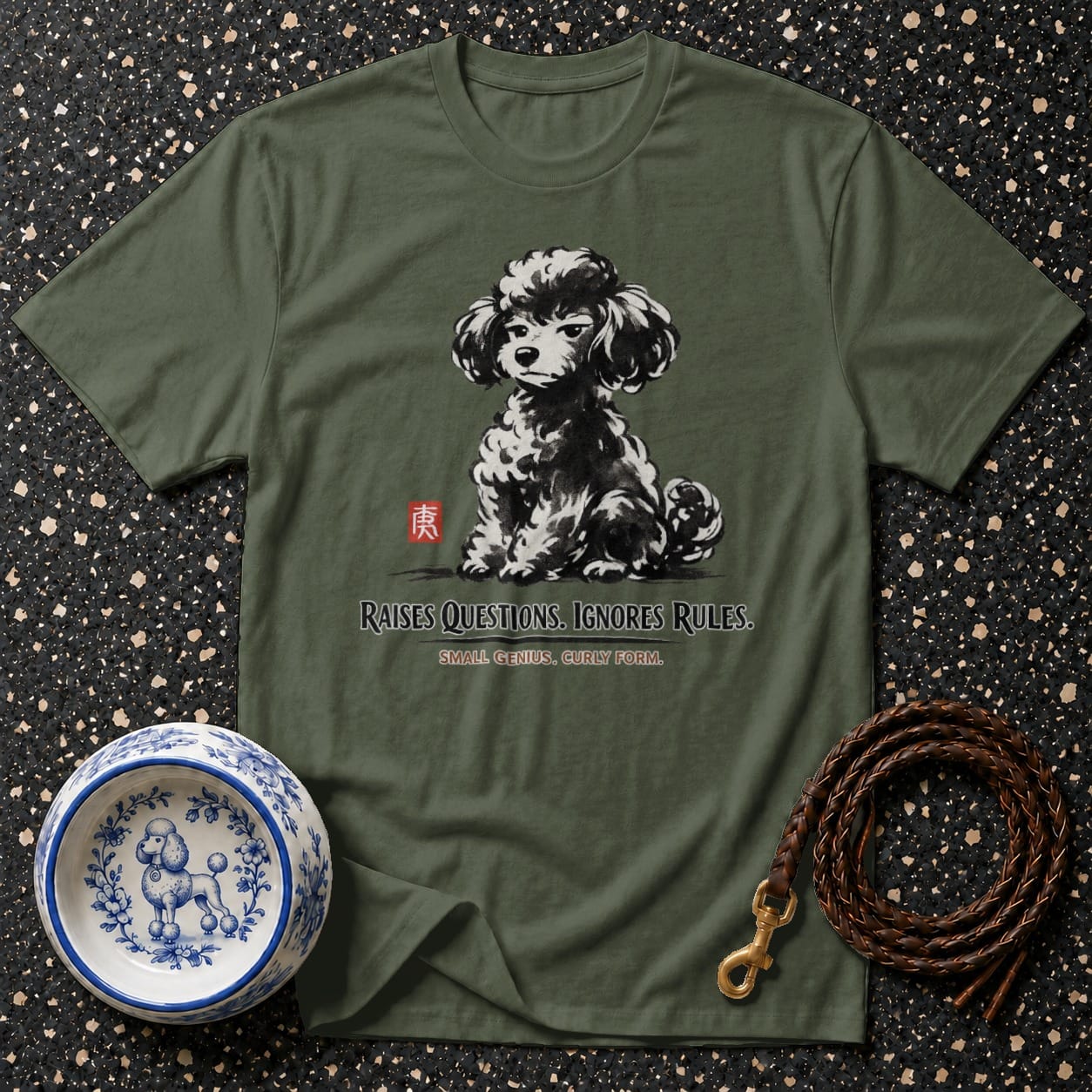 Green t-shirt with black and white poodle graphic, text reads "RAISES QUESTIONS. IGNORES RULES."