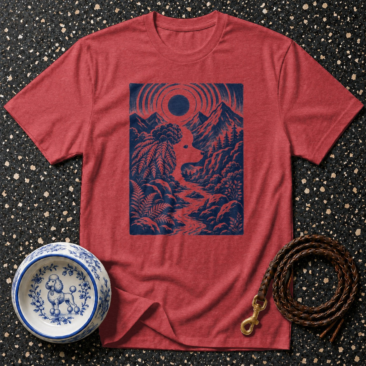 Red t-shirt with blue graphic of a poodle silhouette in a mountain landscape.