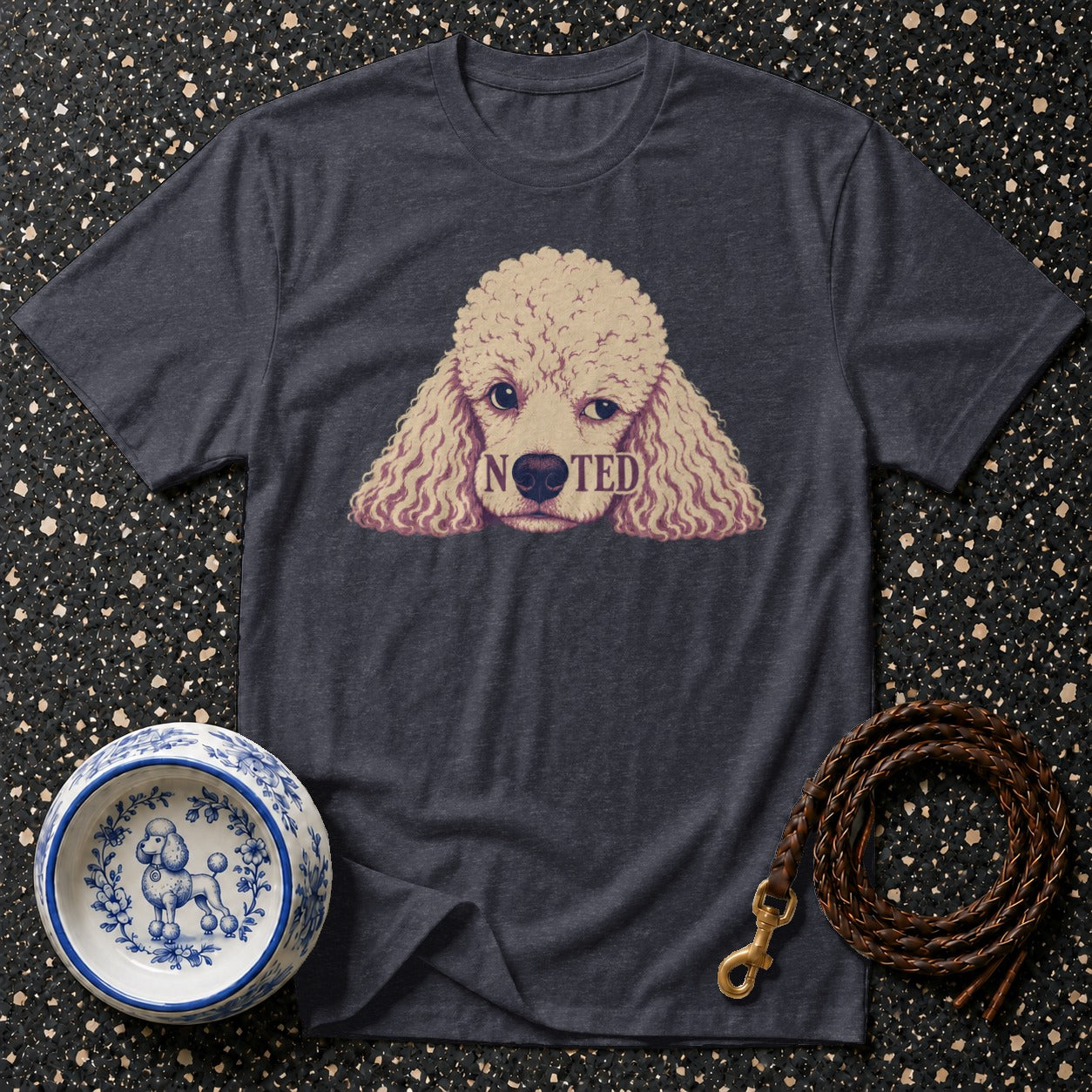 Dark grey t-shirt with a poodle graphic that says "NOTED".