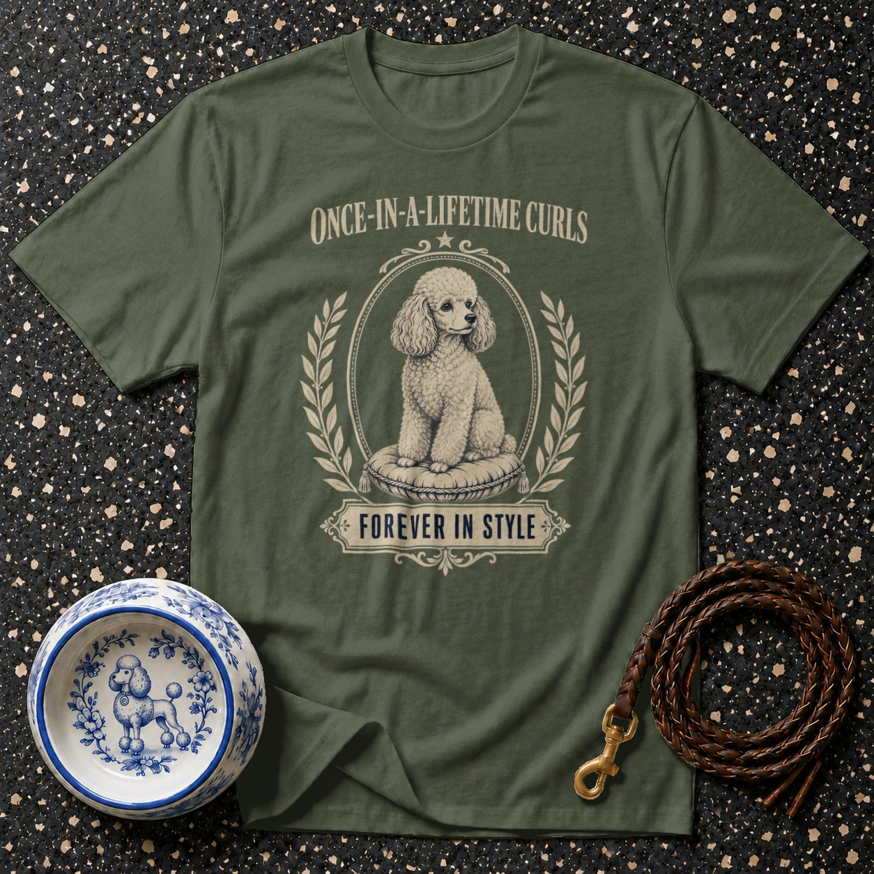 Olive green t-shirt with a poodle illustration and text "Once-in-a-Lifetime Curls Forever in Style".