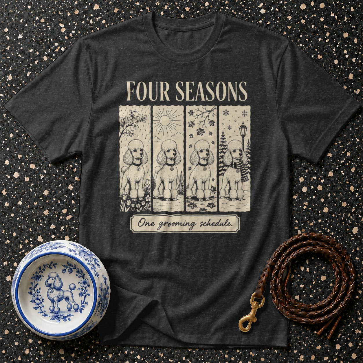 Dark t-shirt with "Four Seasons" and poodles depicted across seasons, with text "One grooming schedule."