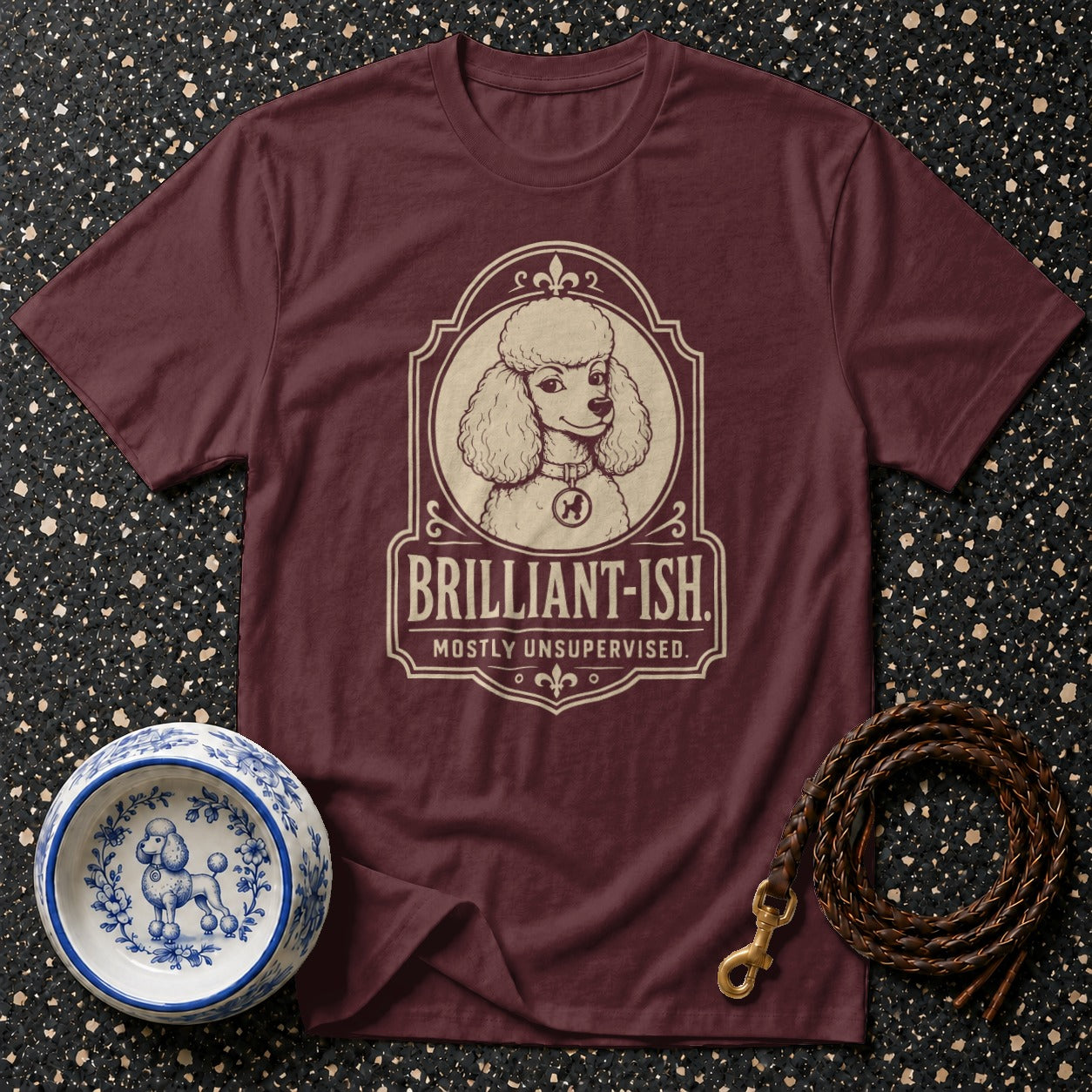 Maroon t-shirt with a poodle graphic and text "BRILLIANT-ISH. MOSTLY UNSUPERVISED."