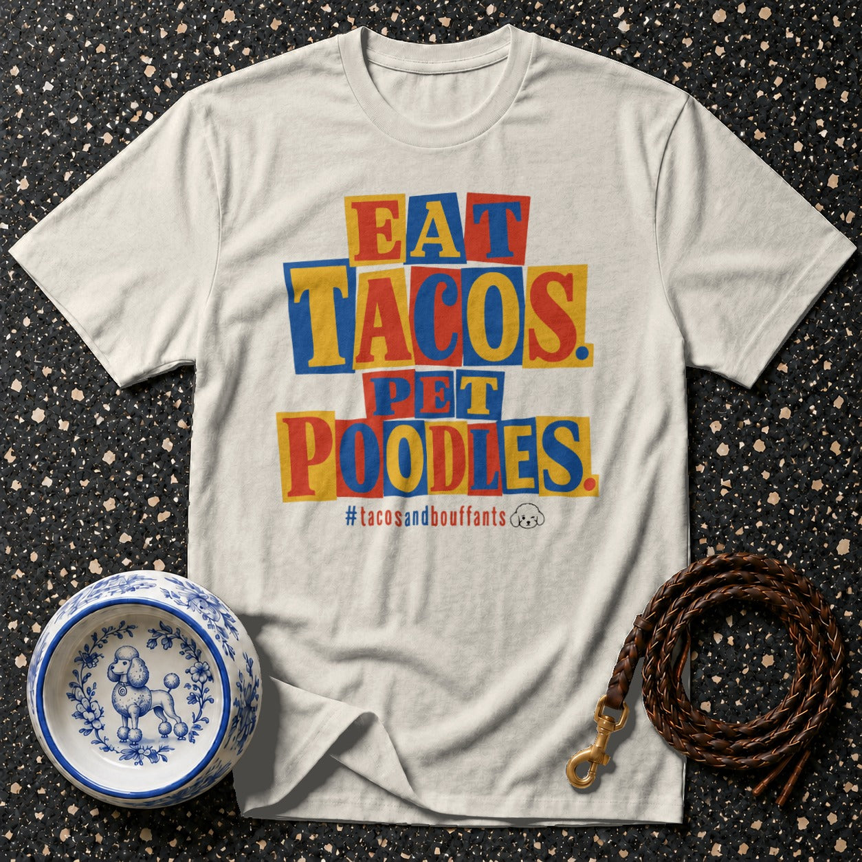 Cream t-shirt with "EAT TACOS PET POODLES" text and #tacosandbouffants hashtag.
