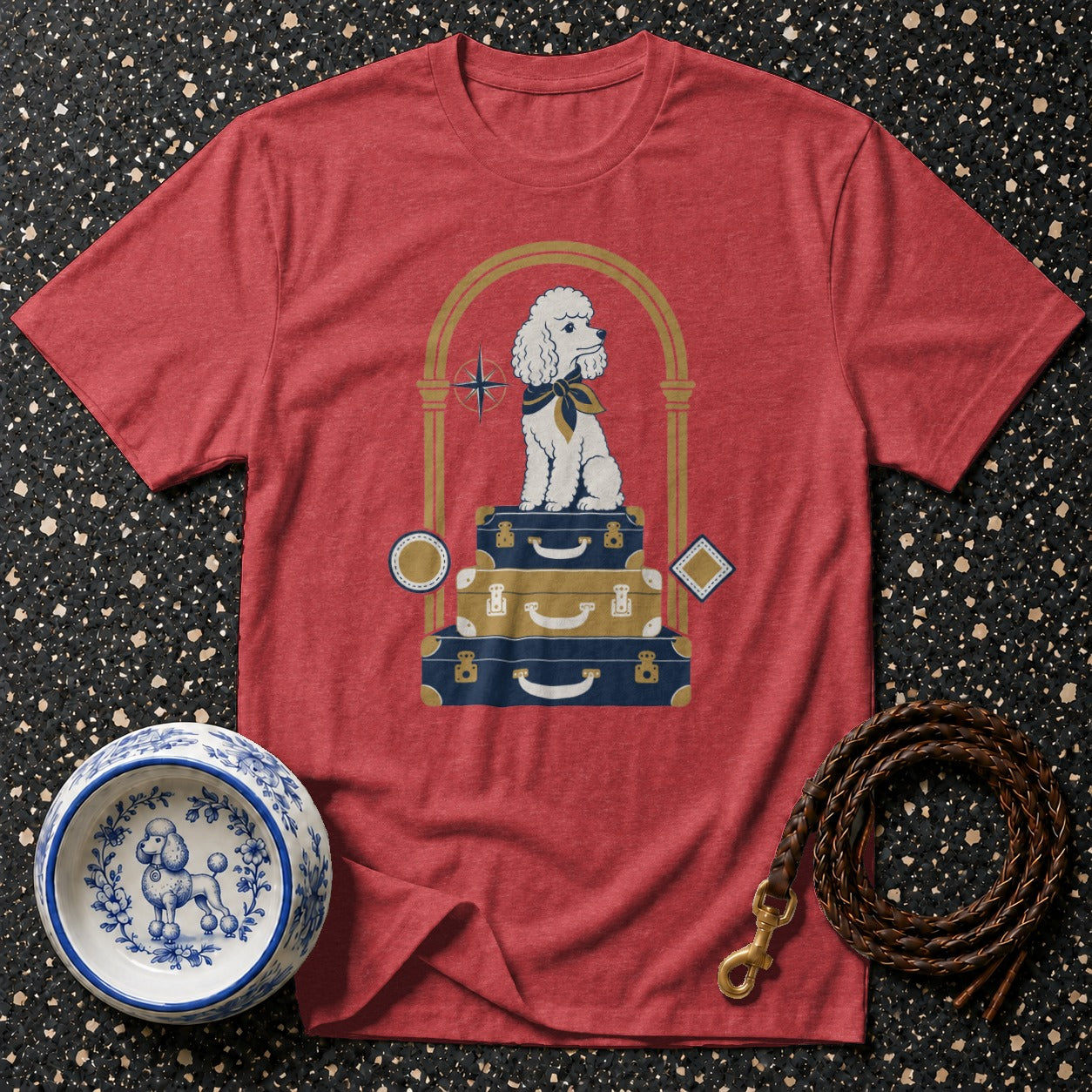 Red t-shirt with a white poodle sitting on stacked luggage within an arch.